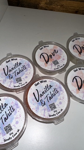 Multiple containers of Gel Wax pots with labels, on a white background.